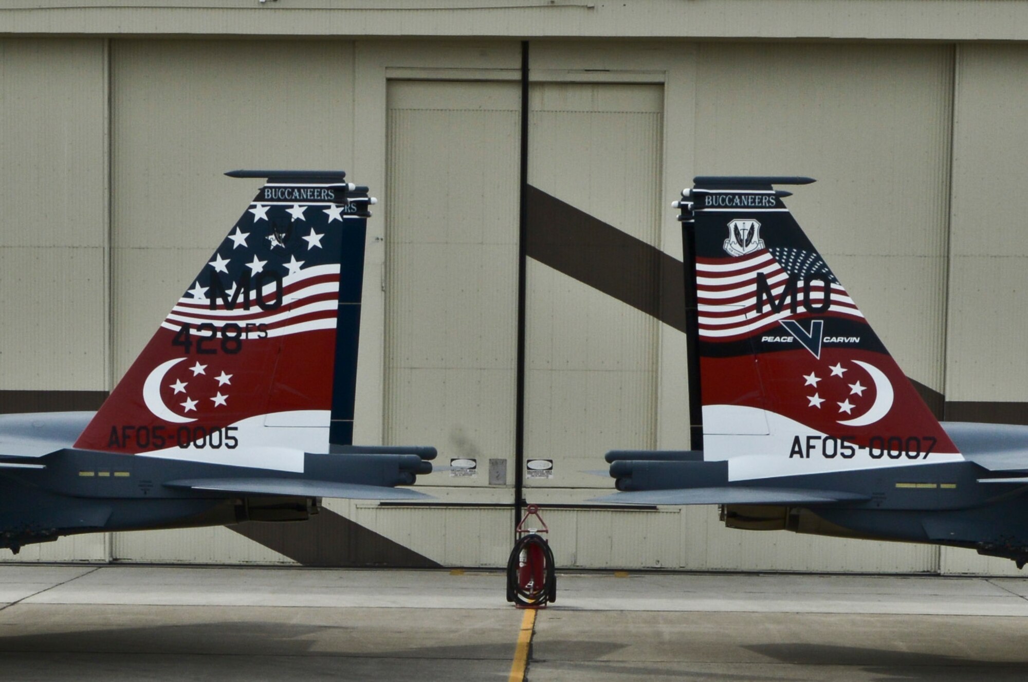 Two Republic of Singapore Air Force F-15SG Strike Eagles are parked to display their new tail flashes outside the Peace Carvin V celebration at Mountain Home Air Force Base, Idaho, May 16, 2014. Mountain Home Air Force Base, Idaho has proven to be the ideal location for the Buccaneers to train on the RSAF’s newest fighter platform, as the base controls and maintains almost 7,500 square miles of operational range space complete with emitter sites to simulate opposing forces. Access to airspace and ranges allows for realistic, safe training and testing, while providing flexibility to accommodate preparation for the allied nations – all culminating in world-class instruction. (U.S. Air Force photo by Master Sgt. Kevin Wallace/RELEASED)