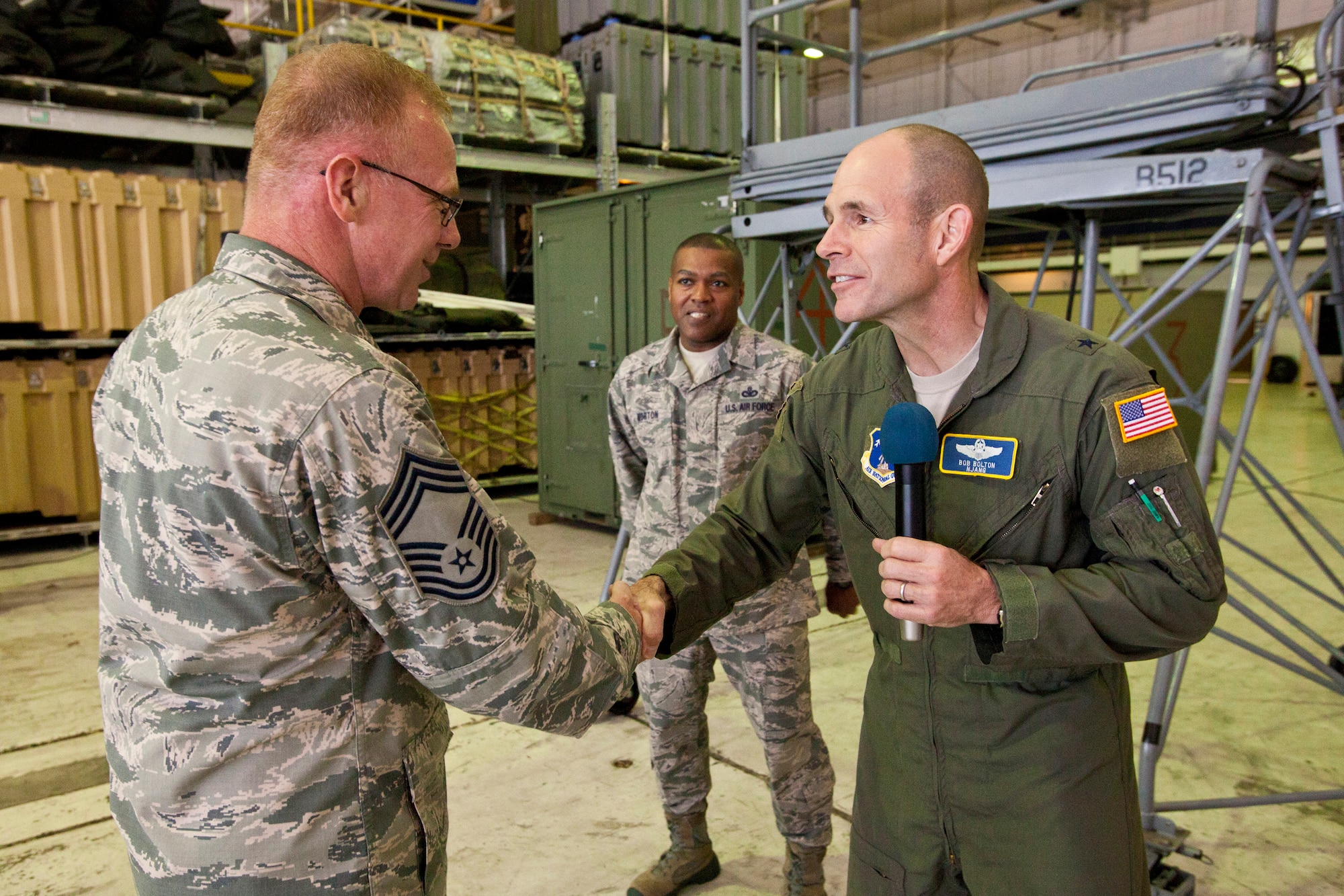 Brig. Gen. Robert C. Bolton, commander, New Jersey Air National Guard, coins Chief Master Sgt. Harry Johnson, 108th Wing Logistics Readiness Squadron, New Jersey Air National Guard, May 21, 2014 at Joint Base McGuire-Dix-Lakehurst, N.J. The Wing underwent a Unit Effectiveness Inspection, which began on May 14 and ended May 18. Highly effective is the second highest grade a unit can receive in a UEI and it is the highest grade that has been given to date in this new inspection system. The UEI is part of the new Air Force Inspection System, which places a priority on continuous unit readiness verified by self-inspection and wing-based inspections. (U.S. Air National Guard photo by Master Sgt. Mark C. Olsen/Released) (This image was cropped to focus on the subject of the image)