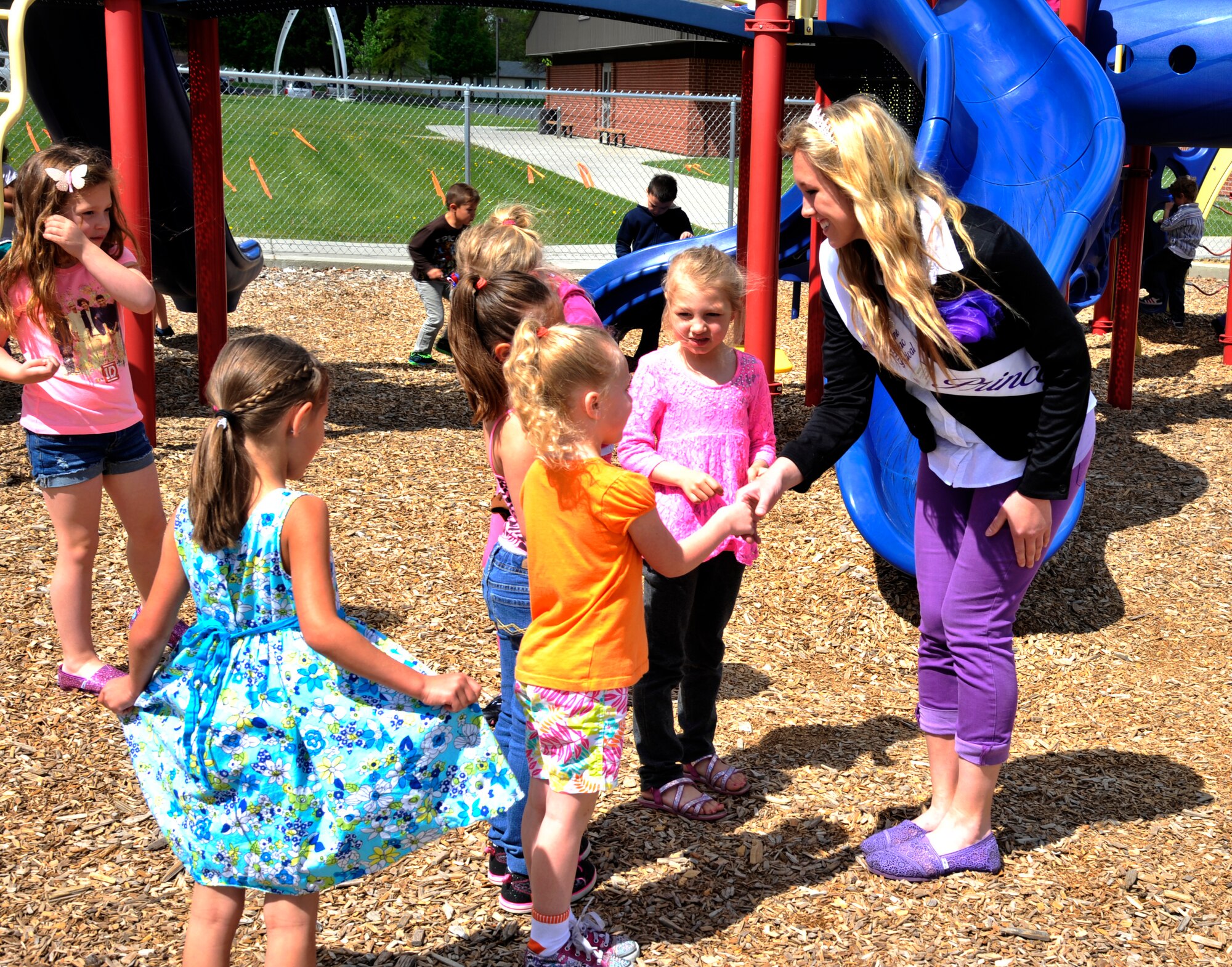 Madison Degeest meets with students from Michael Anderson Elementary School during a base tour at Fairchild Air Force Base, Wash., May 19, 2014. During the tour, Degeest and other members of the 2014 Spokane Lilac Princess Royal Court were able to witness the Team Fairchild mission firsthand. Degeest is a Spokane Lilac Court Princess. (U.S. Air Force photo by Senior Airman Mary O'Dell/Released)