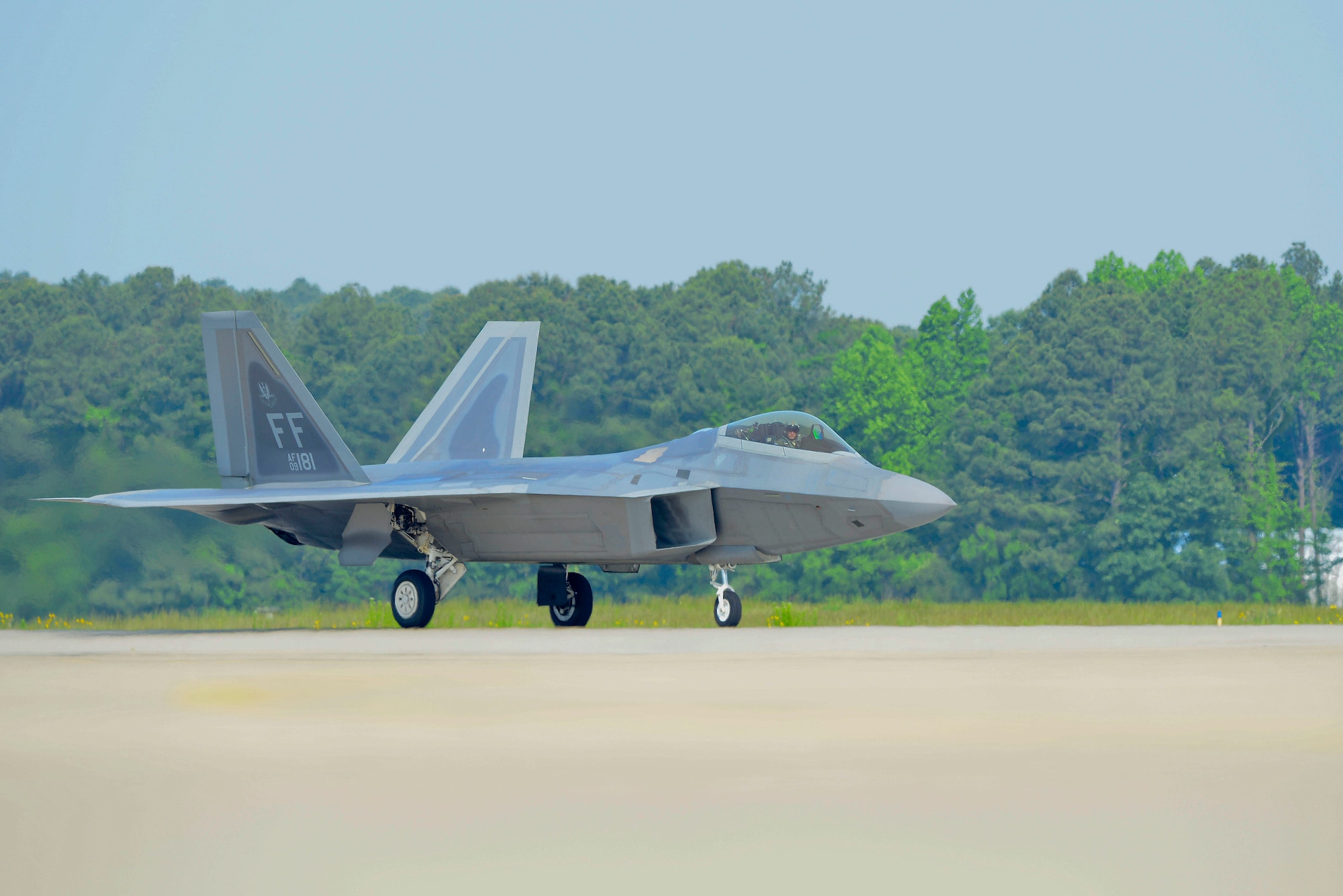 U.S. Air Force Capt. John “Taboo” Cummings 1st Fighter Wing F-22 pilot lands a F-22 Raptor after an aerial demonstration at Langley Air Force Base, Virginia, May 21, 2014. The Air Combat Command F-22 Demonstration Team performs precision aerial maneuvers to demonstrate the unique capabilities of the F-22. (U.S. Air Force photo by Staff Sgt. Antoinette Gibson/Released)