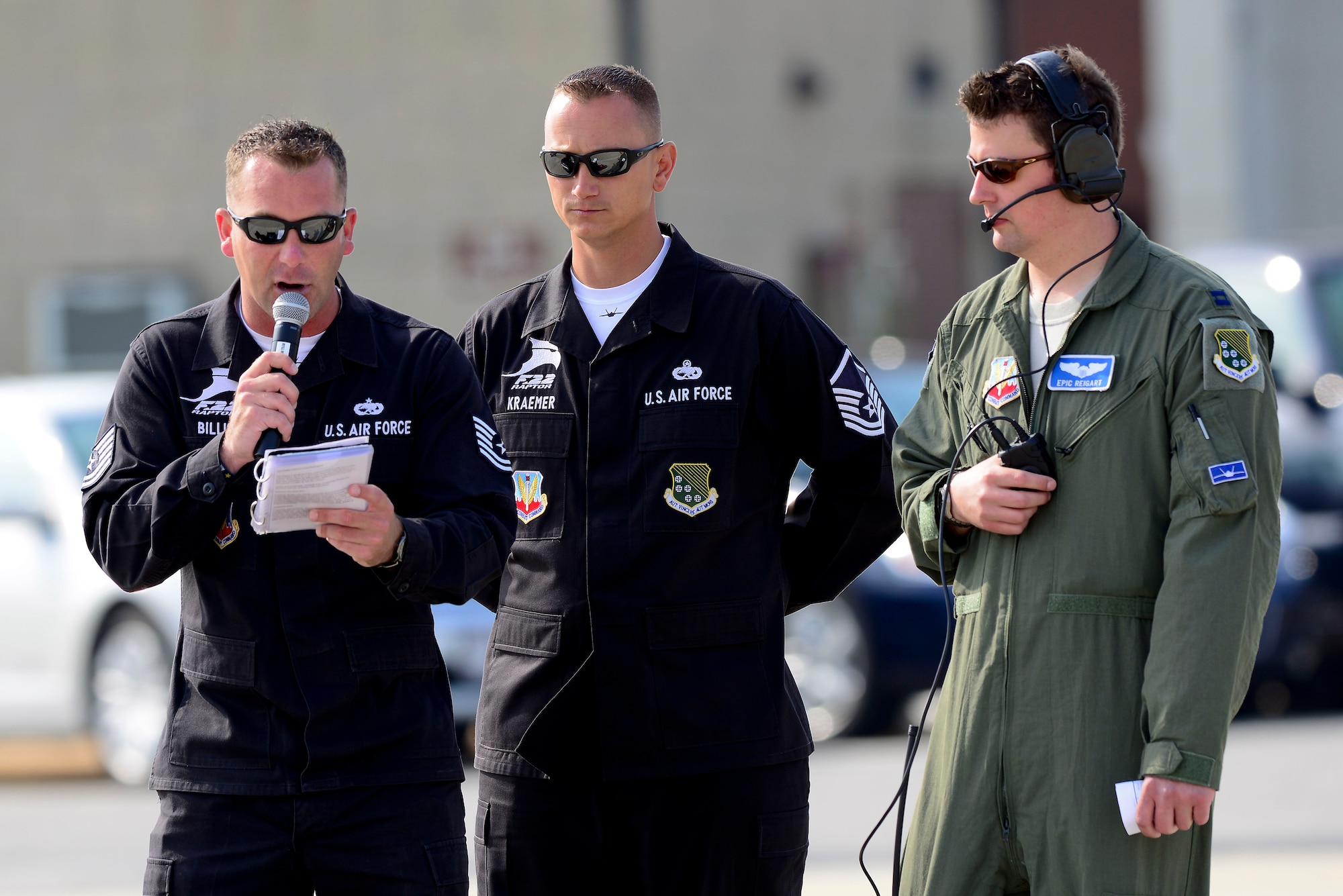U.S. Air Force Tech. Sgt. Jonathan Billie, Air Combat Command F-22 Demonstration Team chief, narrates the aerial demonstration along-side Master Sgt. Jason Kramer, team superintendent, and Capt. Jason “Epic” Reigart, team chief of mobility during a 1st Fighter Wing Media Day at Langley Air Force Base, Virginia, May 21, 2014. The event offered local media outlets the  opportunity to get a first-hand look at the F-22 Raptor in the air and on the ground, and speak with crewmembers, pilots and leadership about the aircraft’s role in the Air Force mission. (U.S. Air Force photo by Staff Sgt. Antoinette Gibson/Released)