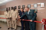 U.S. Air Force Col. Richard D. Anderson (center), Defense Language Institute English Language Center commandant, cuts the ribbon unveiling an International Wall of Fame during DLIELC's Anniversary Celebration May 9 at Joint Base San Antonio-Lackland. The new Wall of Fame depicts prominent DLIELC graduates from throughout the years. (U.S. Air Force photo by Johnny Saldivar)