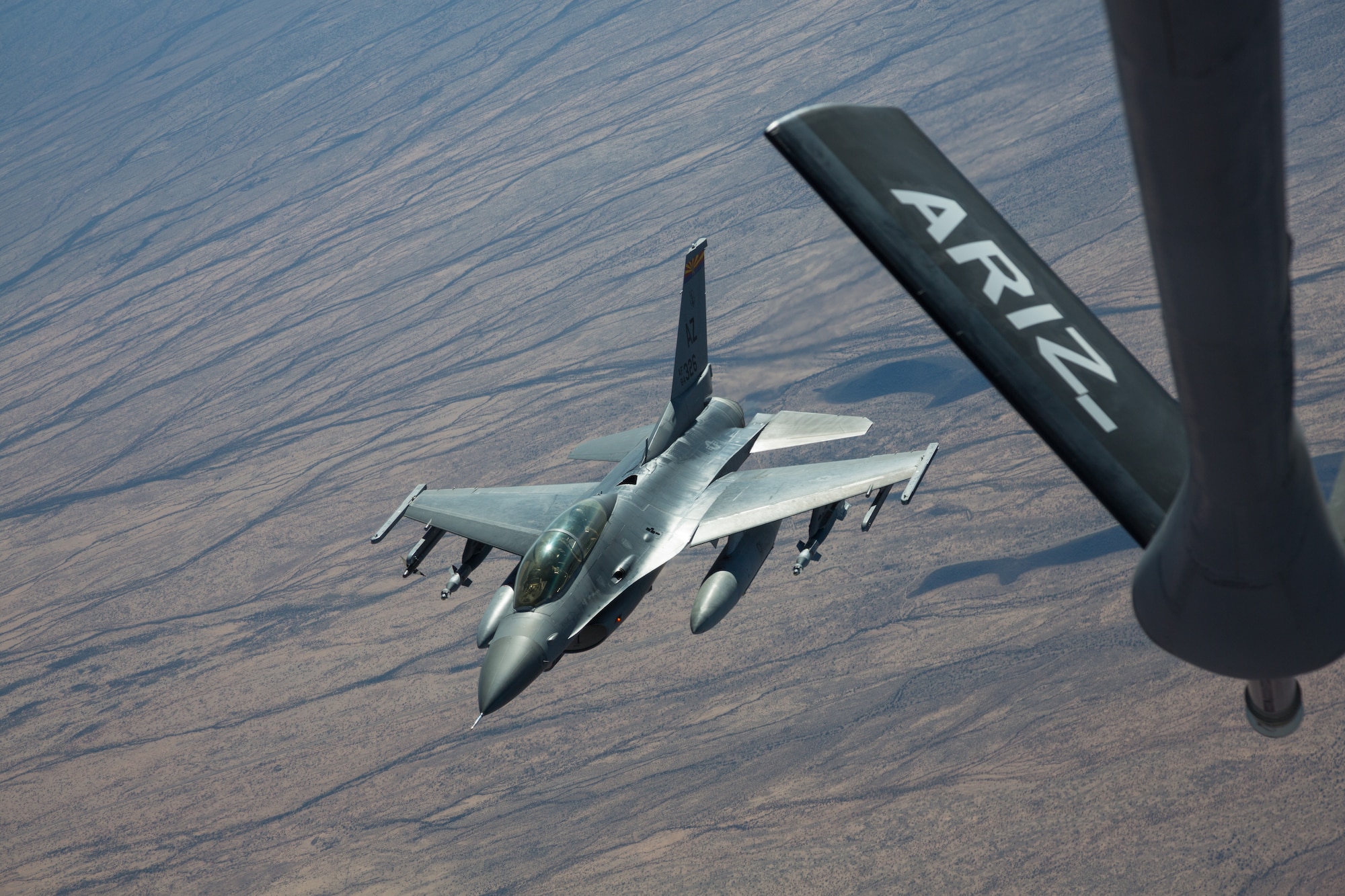 Another satisfied customer in the Arizona skies. After a successful fuel transfer, pilots go about their business – their Fighting Falcons having additional fuel, allowing them to conduct more training, eventually making them a combat-ready air power. “It’s (air refueling) an important skill to learn in the Viper (Fighting Falcon) because it has applicability on any mission we might fly,” said Maj. Brad Balazs, an F-16 instructor attached to the 152nd Fighter Squadron at the 162nd Wing in Tucson, Ariz. (U.S. Air National Guard photo by Tech. Sgt. Hampton Stramler/Released)