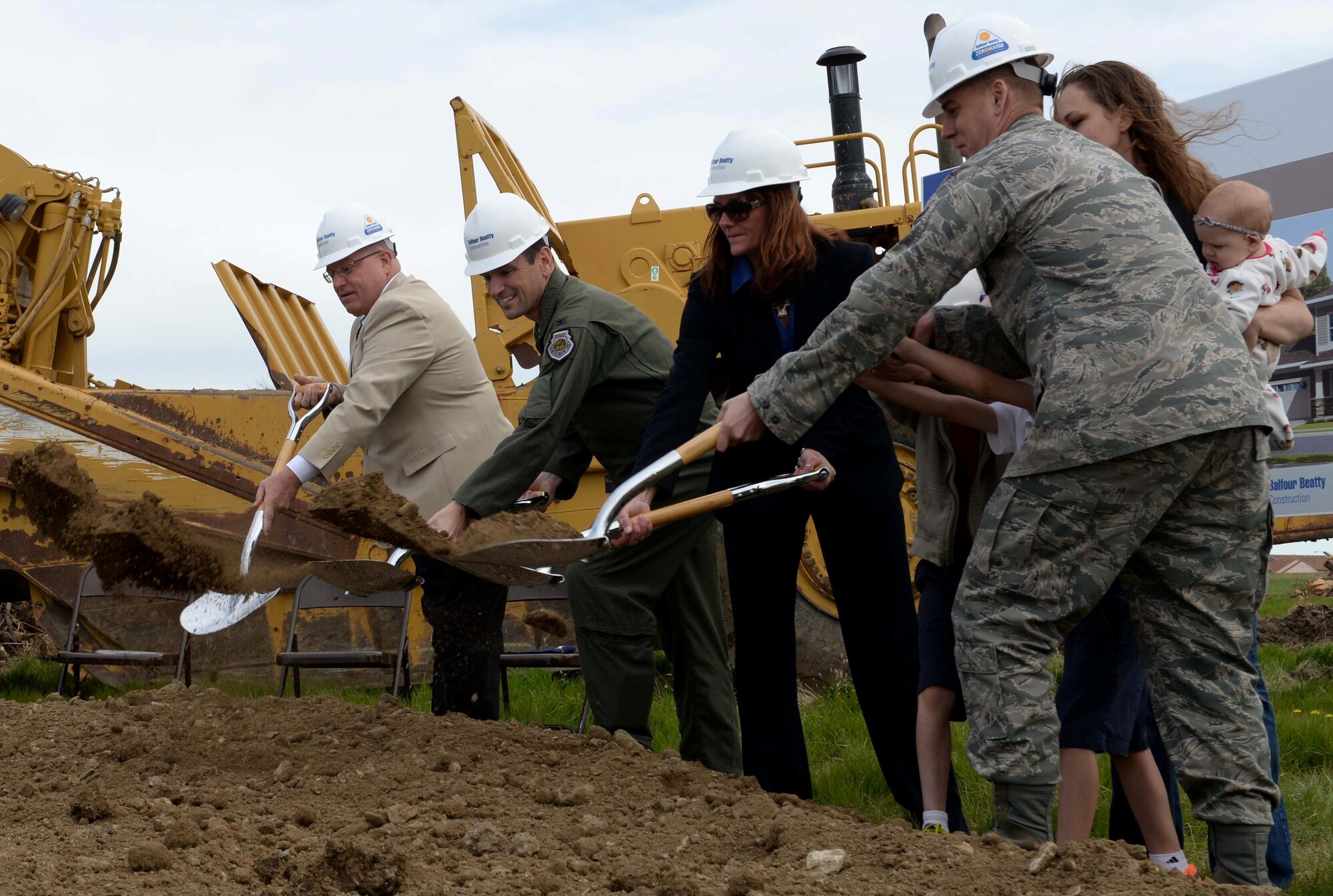 Col. Kevin Kennedy, 28th Bomb Wing commander, performs a groundbreaking ceremony with Balfour Beatty Communities senior officials and an Ellsworth Airman and his family at the new housing development site at Ellsworth Air Force Base, S.D., May 19, 2014.  Ellsworth partnered with BBC to provide 214 residential properties for service members and their families, with the first home becoming available in April 2015. (U.S. Air Force photo by Airman 1st Class Rebecca Imwalle/Released) 