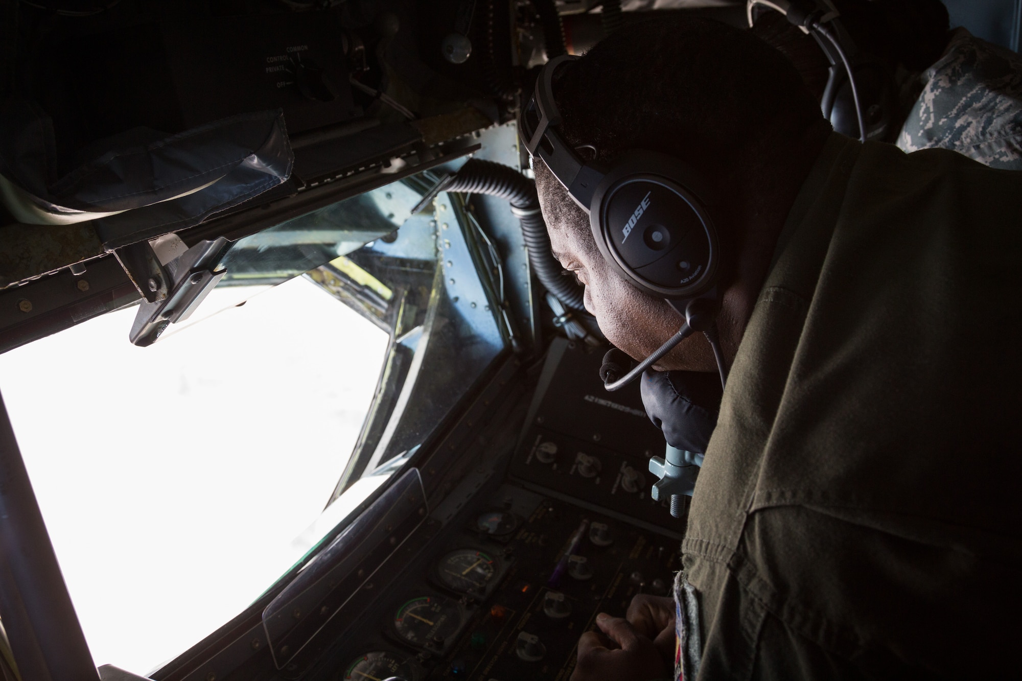 What does your office view look like? With his head positioned on a chin rest and hands on the boom flight control stick and other controls, Master Sgt. Vincent Jones, a boom operator based out of the 161st Air Refueling Wing in Phoenix, Ariz., makes sure that contact is made between receiver and boom. (U.S. Air National Guard photo by Tech. Sgt. Hampton Stramler/Released)