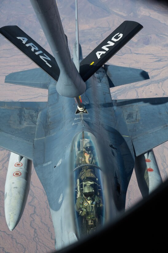 Up close and personal. With an F-16 Fighting Falcon only 20 feet away, fuel flows from a KC-135 through its boom to the multi-purpose fighter. “Air refueling requires the ability to fly formation in a certain position,” said Maj. Brad Balazs, an F-16 instructor attached to the 152nd Fighter Squadron at the 162nd Wing in Tucson, Ariz. “Chances are good that if you can't fly formation correctly, you probably aren't going to be able to master the more difficult tactical skill sets.” (U.S. Air National Guard photo by Tech. Sgt. Hampton Stramler/Released)