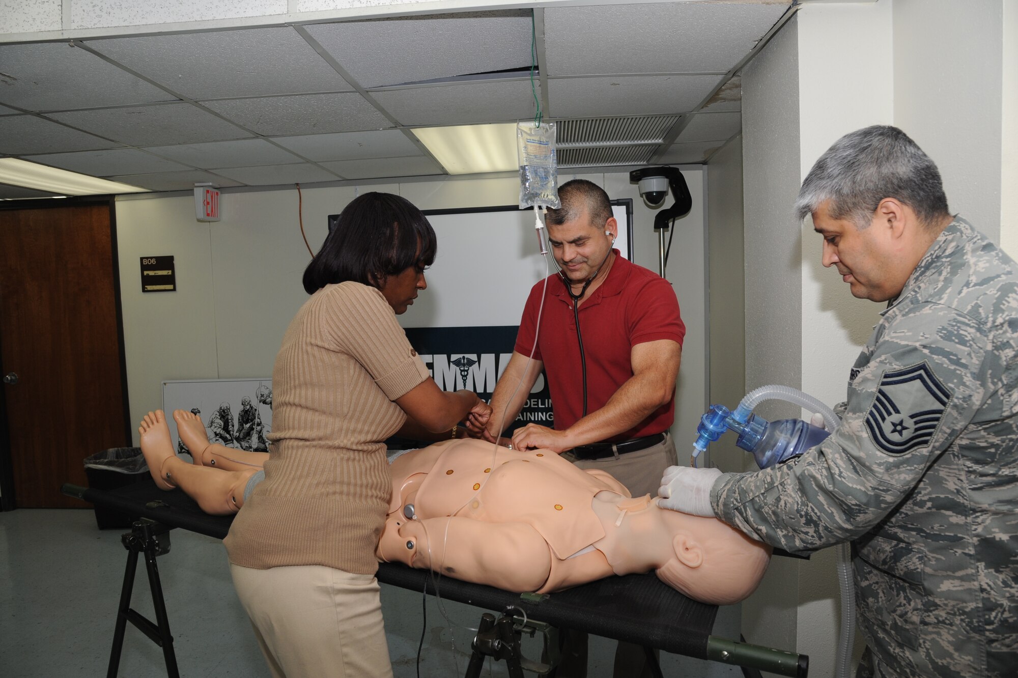 Maya Machacon, left, Air Force Medical Modeling and Simulation Training curriculum specialist, instructs Ruben Garza, center, AFMMAST program deputy chief and administrator, and Senior Master Sgt. Juan Rodriquez, AFMMAST program manager, on how to resuscitate a dummy “patient” May 9 during a simulation of an AFMMAST class at Joint Base San Antonio-Randolph. Scenarios that medics are evaluated on during the AFMMAST program include: evaluation of sepsis, cardiac arrest, testing for a dehydrated troop, determining hypertensive crisis, acute chest pain evaluation and acute hemolytic reaction. (U.S. Air Force photo/Airman 1st Class Kenna Jackson)