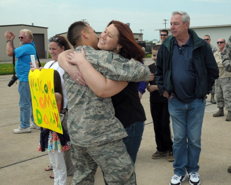 Hugs and kisses for the troops. Family and friends were on hand at the Niagara Falls Air Reserve Station, N.Y.  May 19, 2014 to welcome home members of the 914th Airlift Wing who were deployed overseas. (U.S. Air Force photo by Peter Borys)