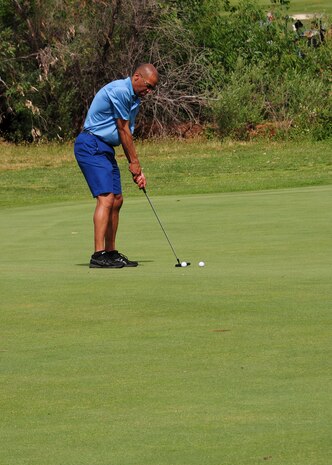 Chief Master Sgt. Leslie Gould, 9th Reconnaissance Wing command chief, putts for a birdie during the Beale Military Liaison Committee golf tournament at the Coyote Run Golf Course on Beale Air Force Base, Calif., May 16, 2014. The four-person, best-ball tournament strengthened ties between the base and local community leaders and provided an opportunity for new honorary commanders to build rapport with their military counterparts. (U.S. Air Force photo by Senior Airman Allen Pollard/Released)