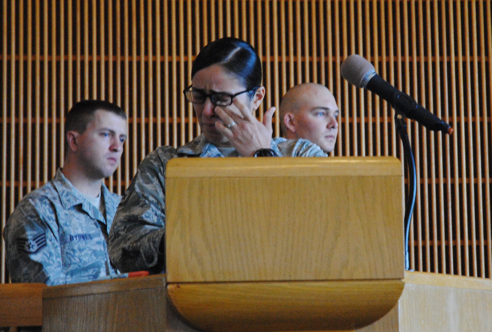 Staff Sgt. Melissa Orozco, 319th Security Forces Squadron Military Working Dog handler, wipes away tears as she speaks about why she enjoyed being MWD Aron’s handler during a memorial service in honor of the Air Force canine held May 15, 2014, at the Prairie Rose Chapel on Grand Forks Air Force Base, N.D. The MWD was humanely euthanized on May 7, 2014, after it was discovered he was dying of cancer. Orozco described the four-legged companion as 80 pounds of love and affection. (U.S. Air Force photo/Staff Sgt. Luis Loza Gutierrez) 
