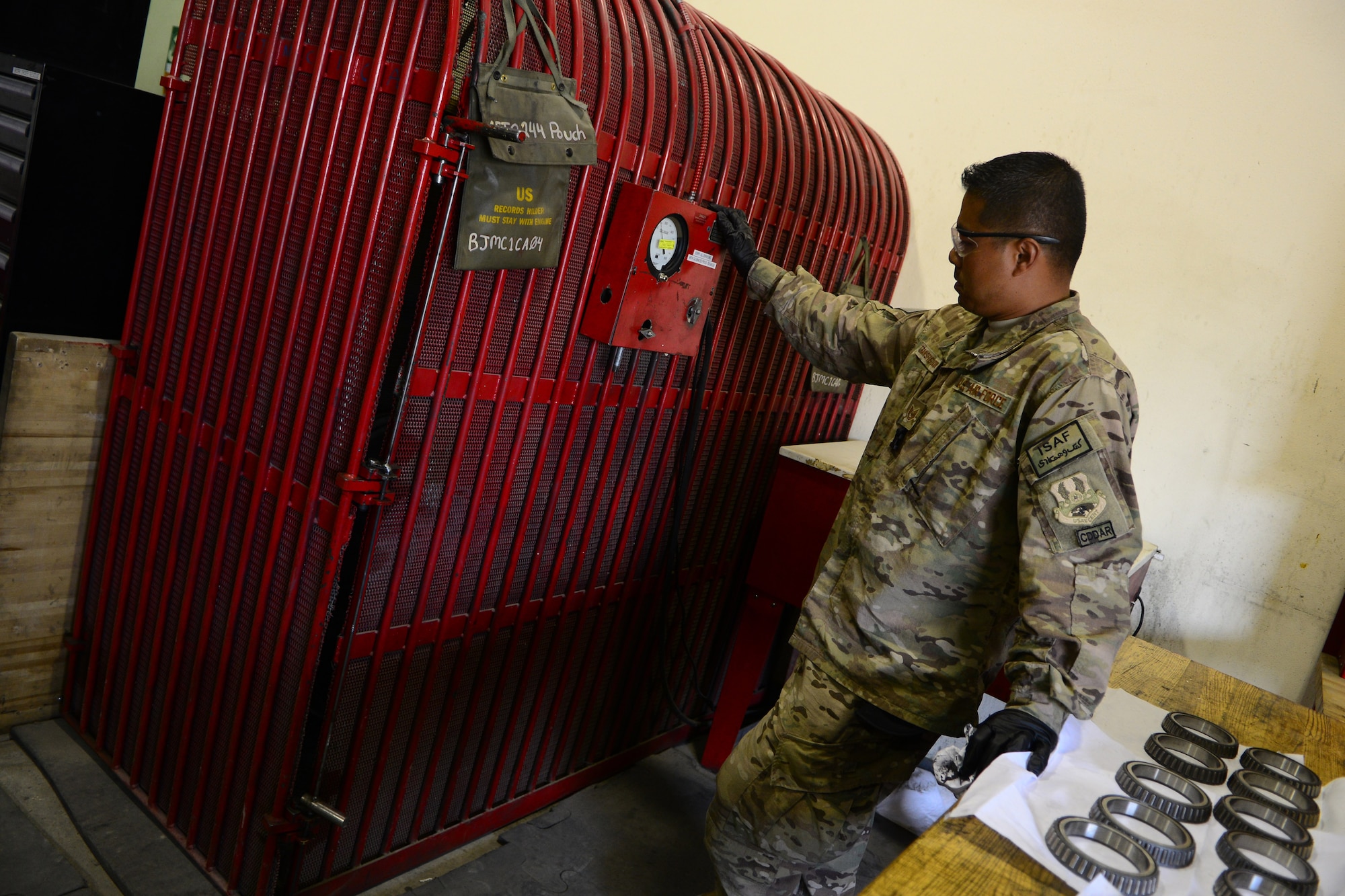 Tech Sgt. Rodney Transfiguracion, 455th Expeditionary Maintenance Squadron crash recovery team chief, inflates a wheel with nitrogen May 19, 2014.  As part of the wheel and tire shop, Transfiguracion ensures serviceable tires are readily available for A-10 Thunderbolt IIs and F-16 Fighting Falcons, as part of their process the shop breaks tires down to the bearing, clean the components and wash all wheels. Tranfiguracion is deployed from Whiteman Air Force Base, Mo. and a native of Whittier, Calif. (U.S. Air Force photo by Staff Sgt. Evelyn Chavez/Released)