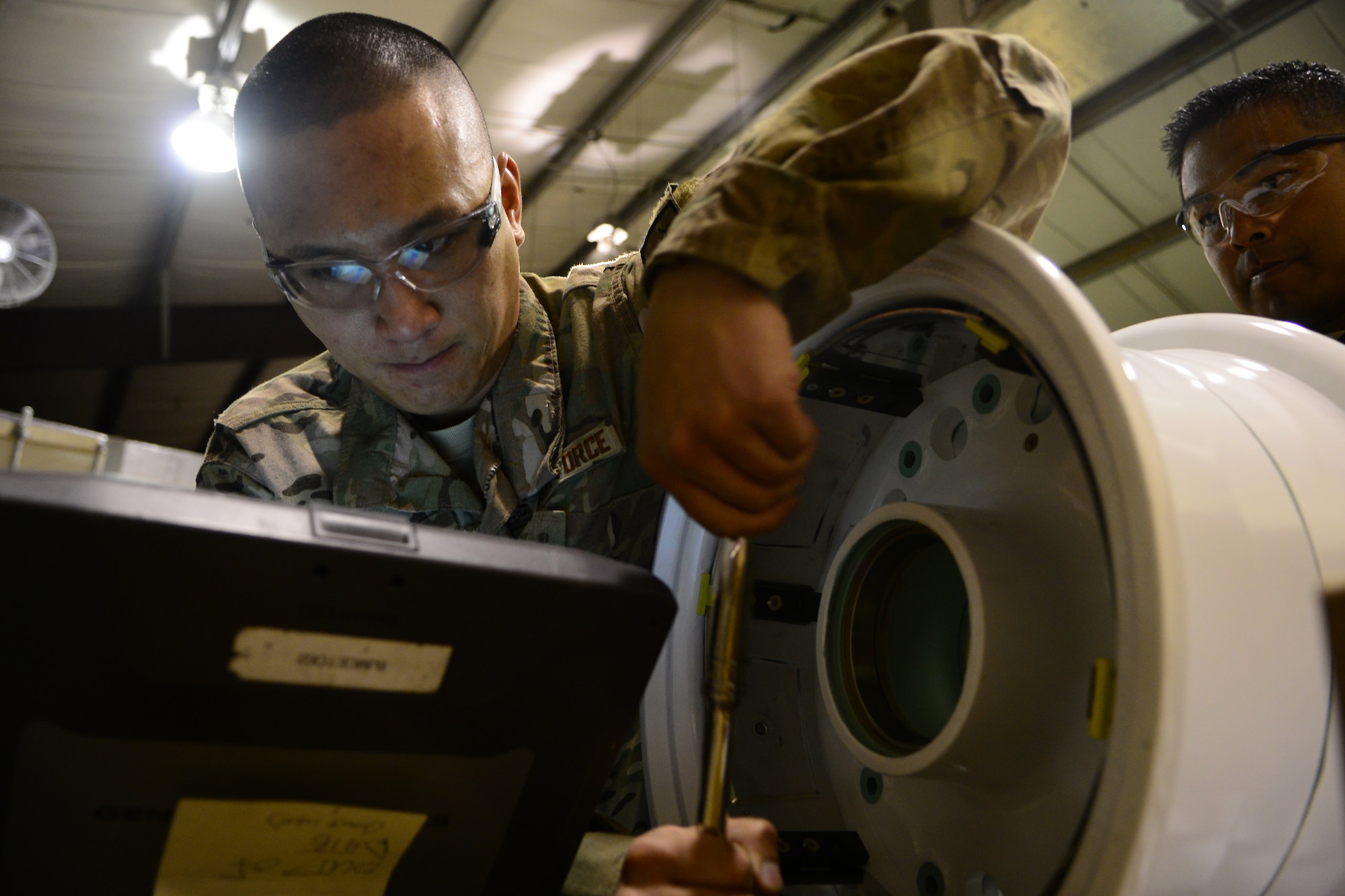 Staff Sgt. John Dang, 455th Expeditionary Maintenance Squadron crash recovery team member, reviews a training order before a wheel and tire assembly May 19, 2014.  As part of the wheel and tire shop, Dang provides serviceable tires for A-10 Thunderbolt IIs and F-16 Fighting Falcons, the shop works on an average of 48 wheels per month.  Dang is deployed from Whiteman Air Force Base, Mo. and a native of Overland Park, Kan.  (U.S. Air Force photo by Staff Sgt. Evelyn Chavez/Released)