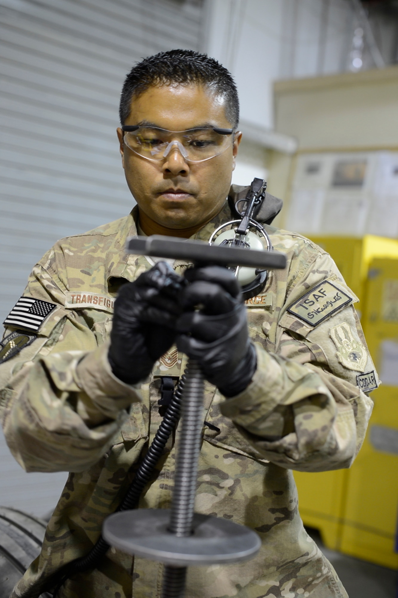 Tech Sgt. Rodney Transfiguracion, 455th Expeditionary Maintenance Squadron crash recovery team chief, prepares part of a wheel before a wheel and tire assembly May 19, 2014.  As part of the wheel and tire shop, Transfiguracion provides serviceable tires for A-10 Thunderbolt IIs and F-16 Fighting Falcons, the shop repairs an average of 48 wheels per month.  Tranfiguracion is deployed from Whiteman Air Force Base, Mo. and a native of Whittier, Calif. (U.S. Air Force photo by Staff Sgt. Evelyn Chavez/Released)