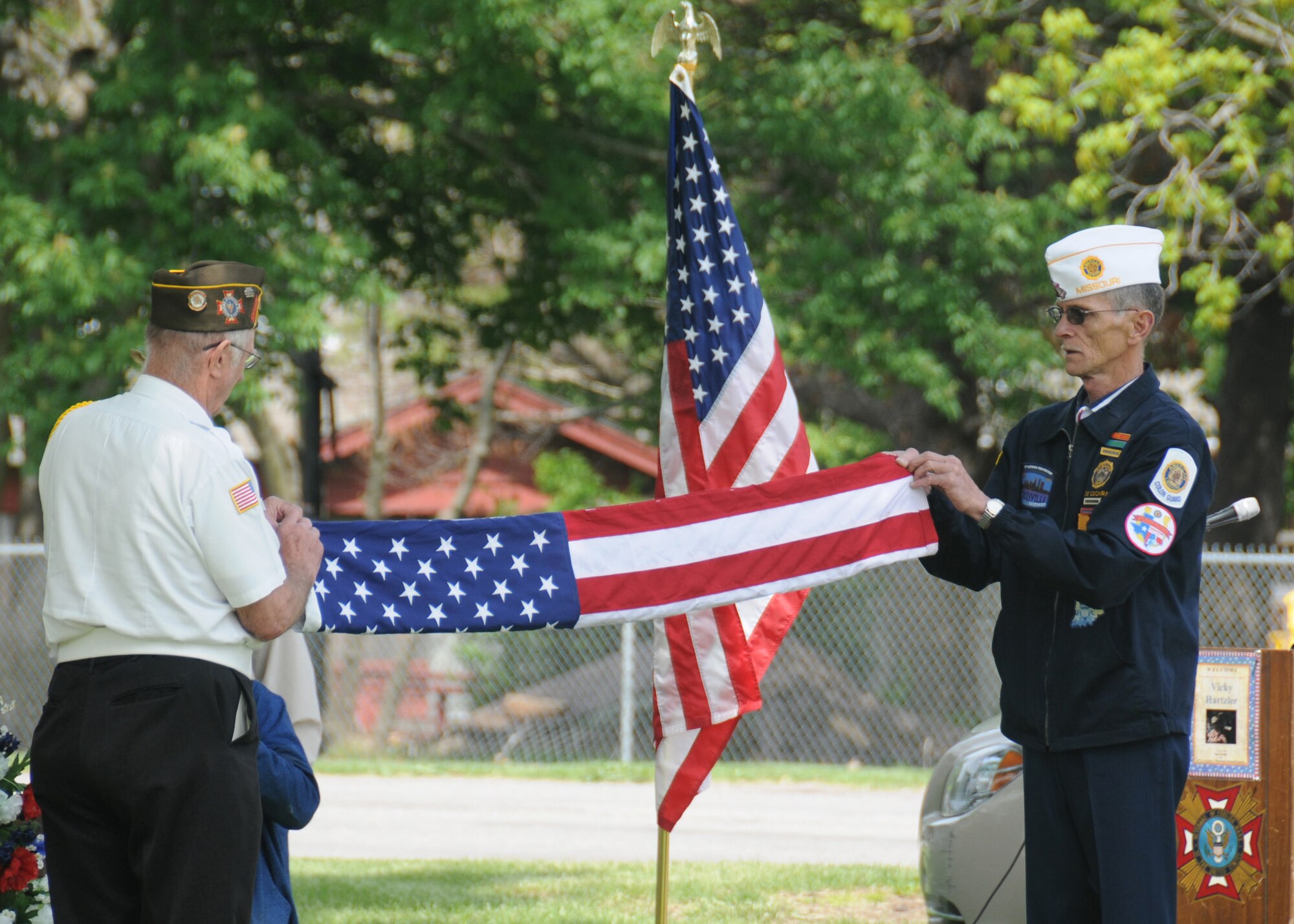 Members of the Sedalia Veterans of Foreign Wars Post 2591 fold the flag that was raised over 2nd Lt. George A. Whiteman’s grave during the Armed Forces Day remembrance ceremony May 17, 2014, in Sedalia, Missouri. The veterans raised the flag and provided a three-shot gun salute during the event. (U.S. Air National Guard photo by Senior Airman Nathan Dampf/Released)