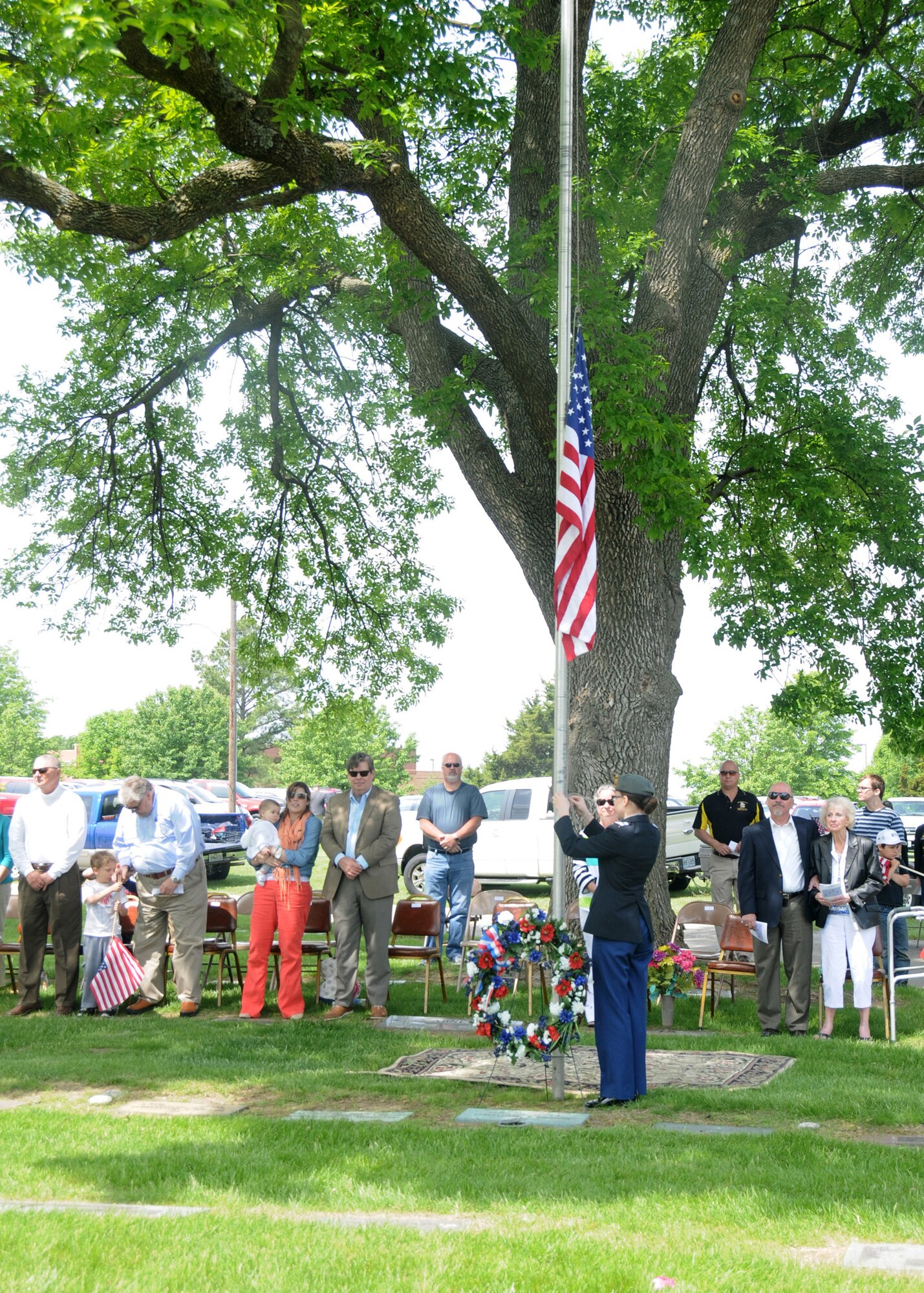 Family members of 2nd Lt. George A. Whiteman look on as Sedalia Smith-Cotton High-School Junior Reserve Officer Training Corps Cadet Megan Wilbanks prepares to lower the flag during the Armed Forces Day ceremony in Sedalia, Missouri., May 17, 2014. More than 50 family members of Whiteman attended the ceremony, carrying on a tradition that began 26 years ago. (U.S. Air National Guard photo by Senior Airman Nathan Dampf/Released)