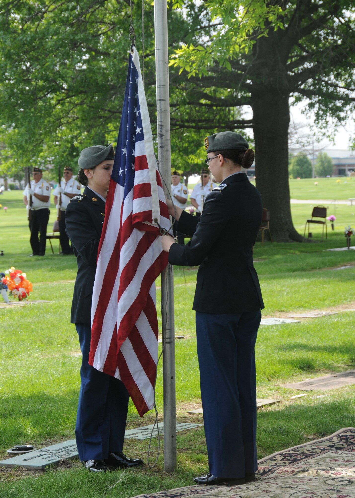 Cadets of the Sedalia Smith-Cotton High School Junior Reserve Officer Training Corps program raise the flag at the grave site of 2nd Lt. George A. Whiteman, May 17, 2014. The cadets participate in the event every year as part of the Sedalia, Mo., community's Armed Forces remembrance ceremony by raising the flag and singing the national anthem. (U.S. Air National Guard photo by Senior Airman Nathan Dampf/Released)