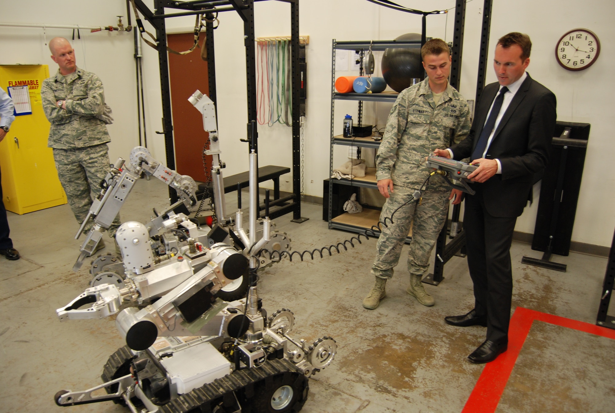 PETERSON AIR FORCE BASE, Colo. – With the instruction of Airman 1st Class Nicholas Stewart, Undersecretary of the Air Force Eric Fanning takes a test-drive with a remote-controlled robot at the 21st Civil Engineer Squadron Explosive Ordnance Disposal flight during his visit to Peterson AFB May 19. While here Fanning visited various facilities including the Area Dental Laboratory and military working dog section to gain insight into the day-to-day lives of Airmen. (U.S. Air Force photo/Michael Golembesky) 
