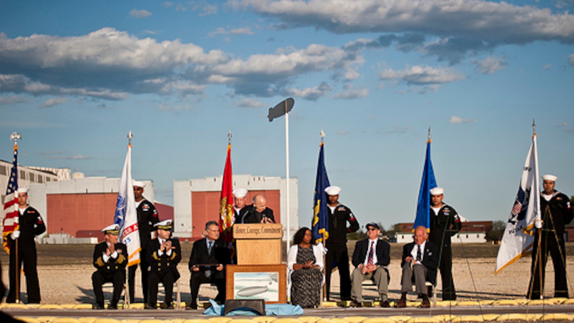 Navy Capt. Christopher Fletcher, Joint Base McGuire-Dix-Lakehurst deputy commander, and Navy Chaplain Lt. Brett Sabella, 87th Air Base Wing chaplain, salute as a color guard retires the colors during the annual Hindenburg Memorial Ceremony May 6, 2014, at JB MDL, N.J. The event was in honor of the 77th anniversary of the tragic Hindenburg airship accident here that claimed the lives of 39 people May 6, 1937. (U.S. Air Force photo by Staff Sgt. Scott Saldukas/Released)  