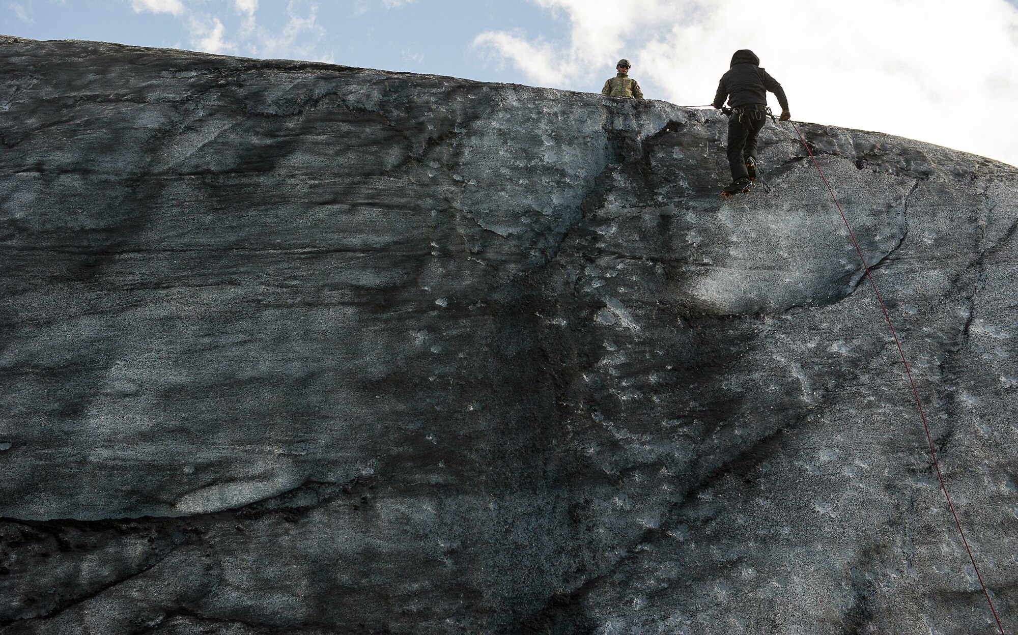 KEFLAVIK, Iceland -- A pararescueman deployed for Icelandic Air Policing rappels down the side of a glacier during training near Keflavik, Iceland, May 18, 2014. Although the Airman’s primary objective is to rescue downed aircrew deployed with the 48th Air Expeditionary Group if needed, the trip provides an opportunity to accomplish training objectives the rescue team wouldn’t ordinarily have access to near Kadena Air Base, Japan, from where they are deployed. (U.S. Air Force photo/Tech. Sgt. Benjamin Wilson) (Released)