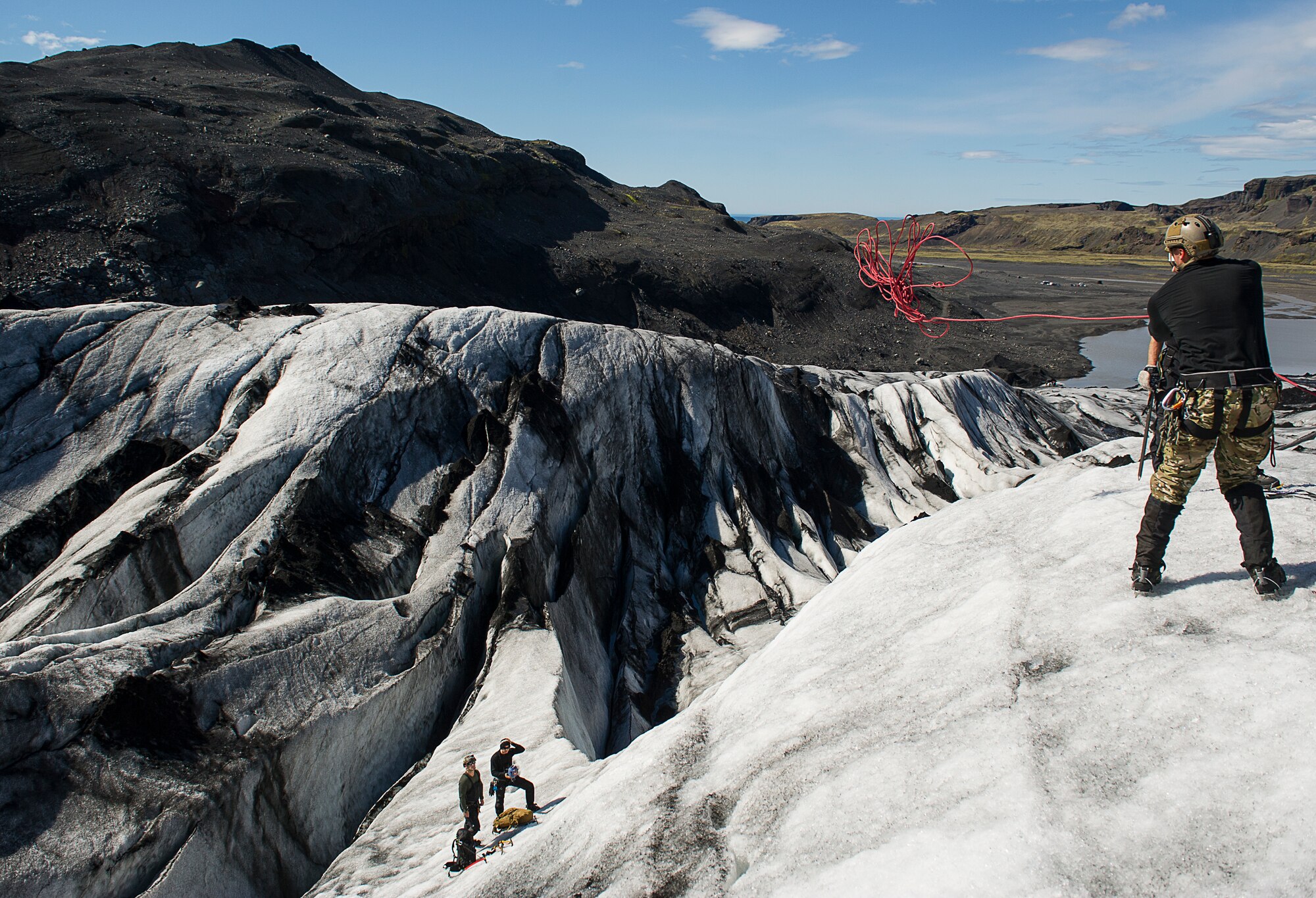 KEFLAVIK, Iceland -- A pararescueman deployed for Icelandic Air Policing throws a rope to his teammates during training on a glacier near Keflavik, Iceland, May 18, 2014. Although the Airmen’s primary objective is to rescue downed aircrew deployed with the 48th Air Expeditionary Group if needed, the trip provides an opportunity to accomplish training objectives the team wouldn’t ordinarily have access to near Kadena Air Base, Japan, from where they are deployed. (U.S. Air Force photo/Tech. Sgt. Benjamin Wilson) (Released)