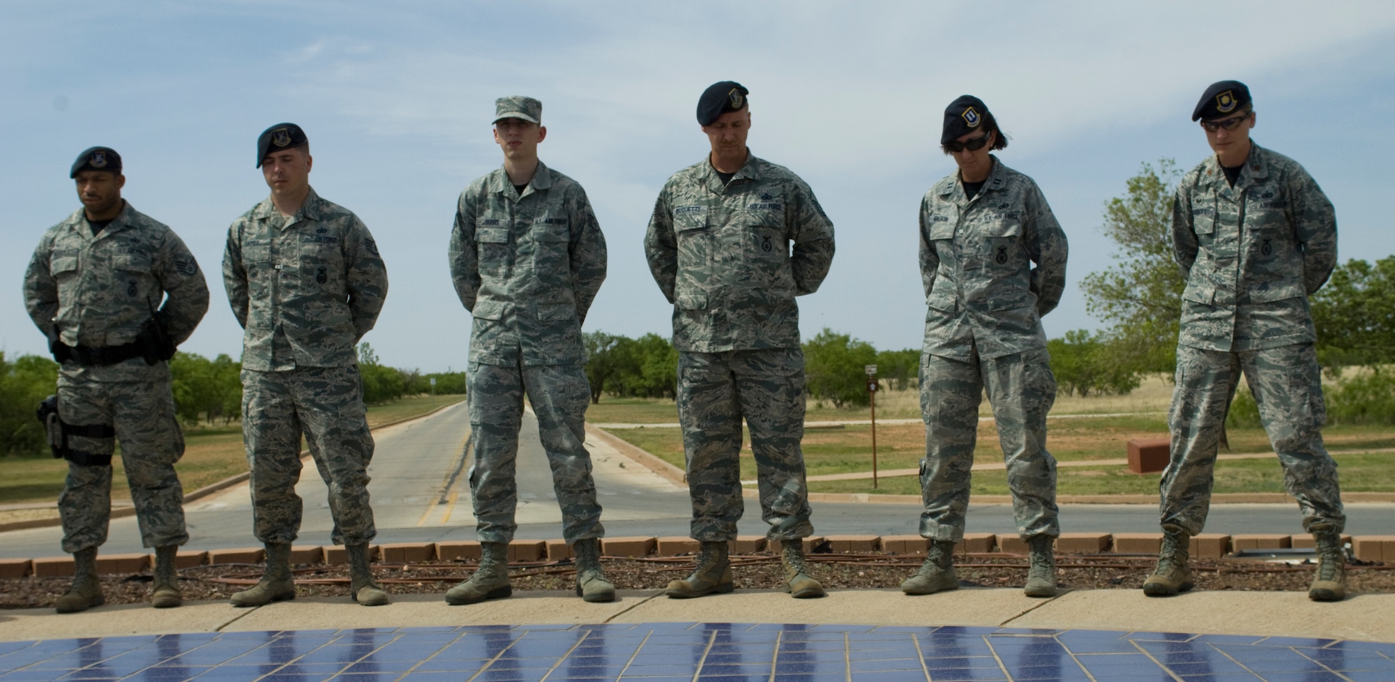 Airmen from the 7th Security Forces Squadron, gather for a moment of silence to honor fallen defenders May 16, 2014, at Dyess Air Force Base. National Police Week pays special recognition to law enforcement officers who have lost their lives in the line of duty for the safety and protection of others. (U.S. Air Force photo by Airman 1st Class Kylsee Wisseman/Released)