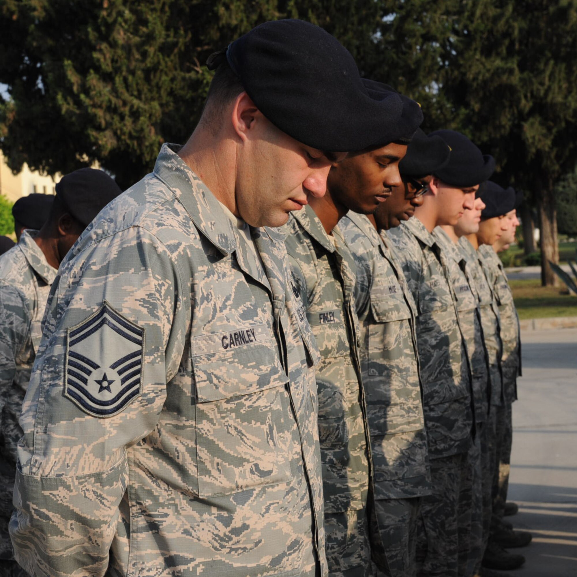 39th Security Forces Squadron members observe a moment of silence during a police week vigil May 16, 2014, Incirlik Air Base, Turkey. The Incilik police week included a weapons display, K9 demo and a children’s story time at the Incirlik library. (U.S. Air Force photo by Staff Sgt. Eboni Reams/Released)