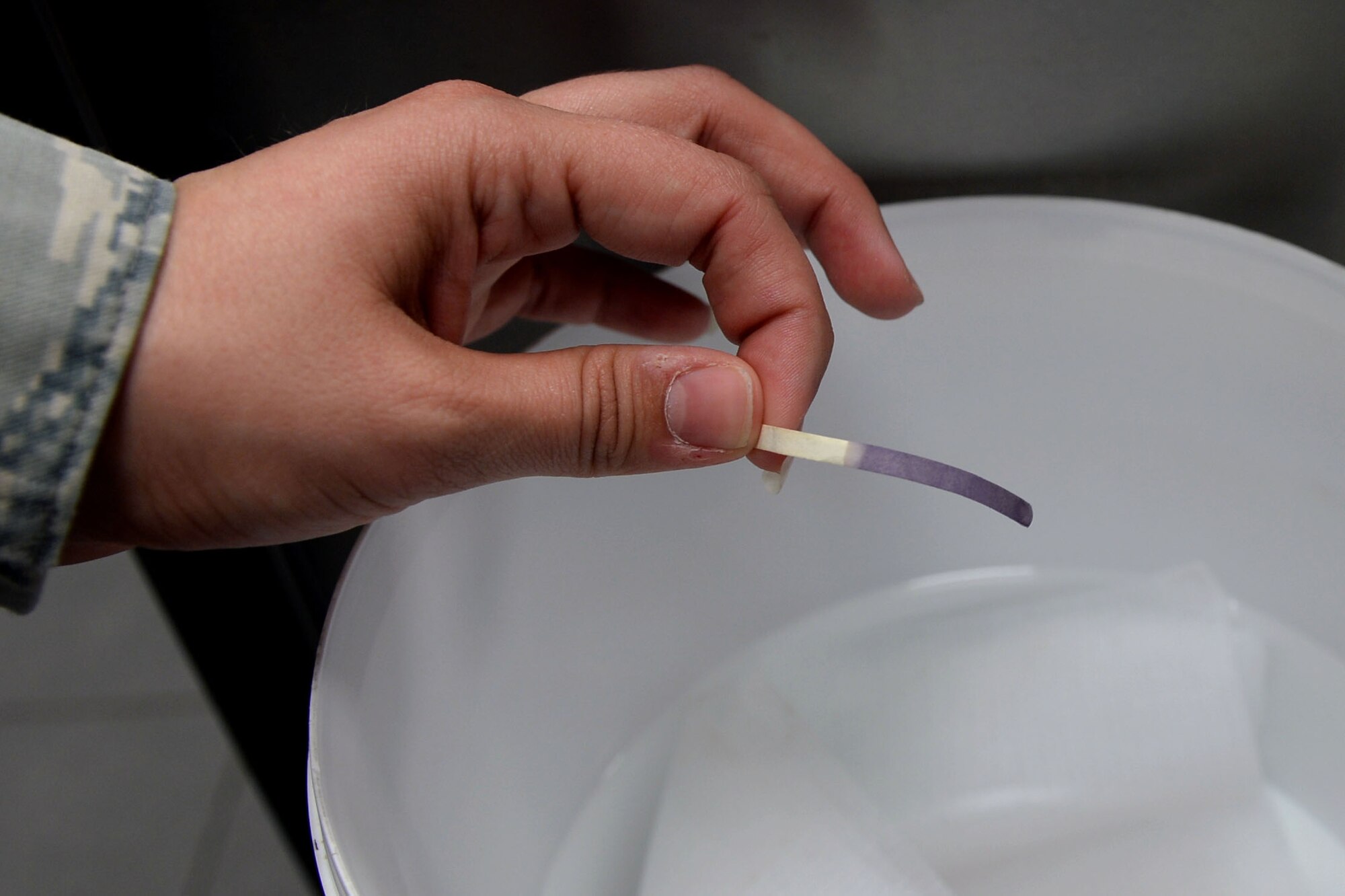 U.S. Air Force Senior Airman Misty Warner, 52nd Aerospace Medicine Squadron public health food safety and sanitation technician from Oglesby, Texas, uses a paper strip to test the sanitizing water at the Eifel Mountain Golf Course during a monthly health inspection at Spangdahlem Air Base, Germany, May 20, 2014. Public health technicians use a variety of tools to properly inspect base facilities.  (U.S. Air Force photo by Senior Airman Alexis Siekert/Released)