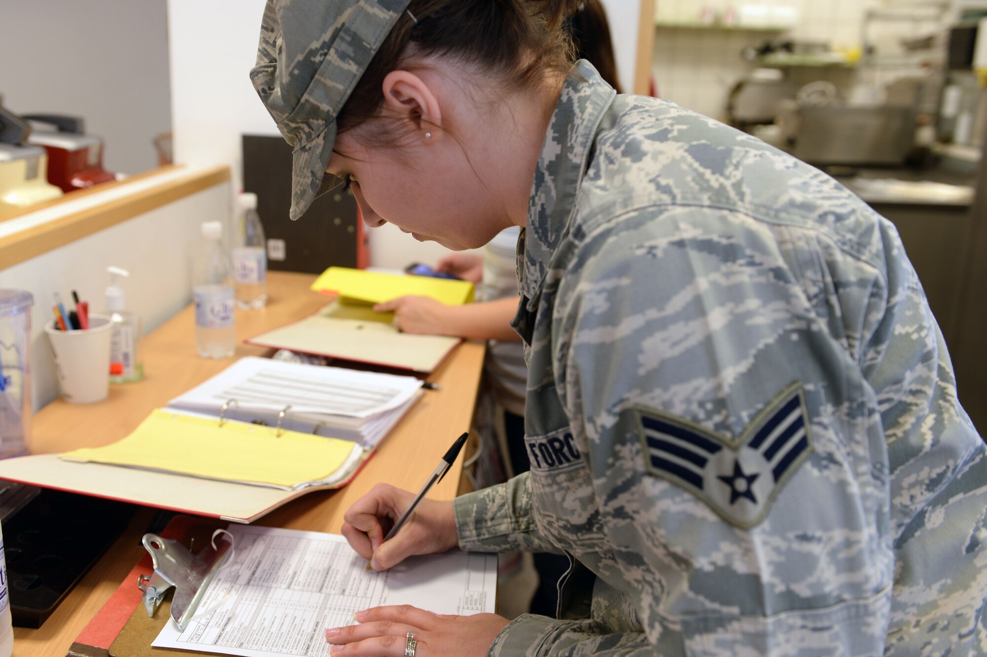 U.S. Air Force Senior Airman Misty Warner, 52nd Aerospace Medicine Squadron public health food safety and sanitation technician from Oglesby, Texas, annotates the completion of self-inspection checklists during a monthly health inspection at the Eifel Mountain Golf Course at Spangdahlem Air Base, Germany, May 20, 2014. The public health technicians’ inspections are one way the 52nd AMDS keeps Spangdahlem safe and healthy. (U.S. Air Force photo by Senior Airman Alexis Siekert/Released))