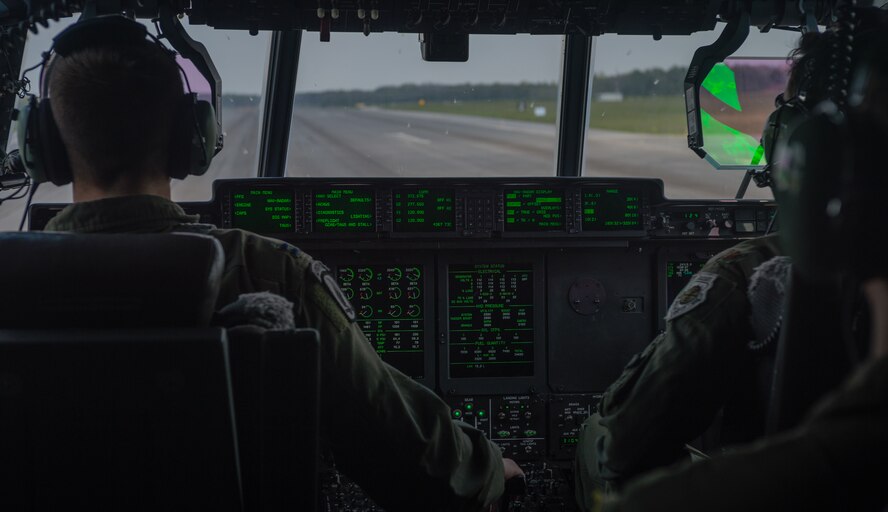 U.S. Air Force Maj. Jeff Bliss, right, a Grand Rapids, Michigan native and Capt. Brett Polage, left, a Mount Vernon, Indiana native, 37th Airlift Squadron pilots, land a C-130J Super Hercules on Amari Air Base, Estonia, May 19, 2014. Pilots and loadmasters from the 37th AS alongside an 86th Aircraft Maintenance Squadron crew chief spent four days across three Baltic countries assisting in personnel drops of allied partners and American service members. (U.S. Air Force photo/Airman 1st Class Jordan Castelan)