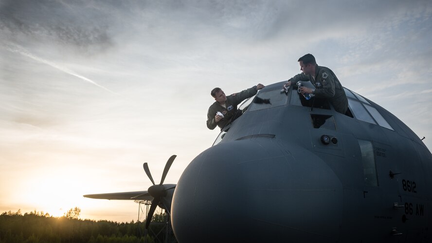 U.S. Air Force Maj. Jeff Bliss, right, a Grand Rapids, Michigan native and Capt. Brett Polage, left, a Mount Vernon, Indiana native, 37th Airlift Squadron pilots, wash the windows of a C-130J Super Hercules at Riga International Airport, Latvia, after air dropping American and Lithuanian service members over Lithuania, May 17, 2014. Pilots and loadmasters from the 37th AS, alongside an 86th Aircraft Maintenance flying crew chief spent four days across three Baltic countries assisting in personnel drops of allied partners and American service members. (U.S. Air Force photo/Airman 1st Class Jordan Castelan)