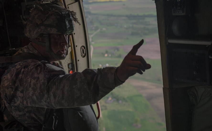 A U.S. Army paratrooper alerts American and Lithuanian paratroopers of the time till the drop over Lithuania, May 17, 2014. Pilots and loadmasters from the 37th AS, alongside an 86th Aircraft Maintenance flying crew chief spent four days across three Baltic countries assisting in personnel drops of allied partners and American service members. (U.S. Air Force photo/Airman 1st Class Jordan Castelan)