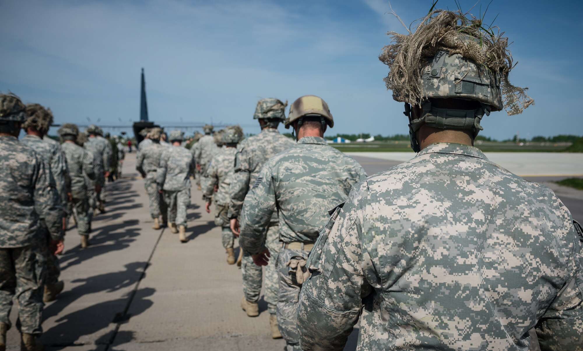 U.S. Airmen and Soldiers prepare to board a 37th Airlift Squadron C-130J Super Hercules alongside Lithuanian paratroopers at Šiauliai International Airport, Lithuania, May 17, 2014. Pilots and loadmasters from the 37th AS alongside an 86th Aircraft Maintenance Squadron crew chief spent four days across three Baltic countries assisting in personnel drops of allied partners and American service members. (U.S. Air Force photo/Airman 1st Class Jordan Castelan)