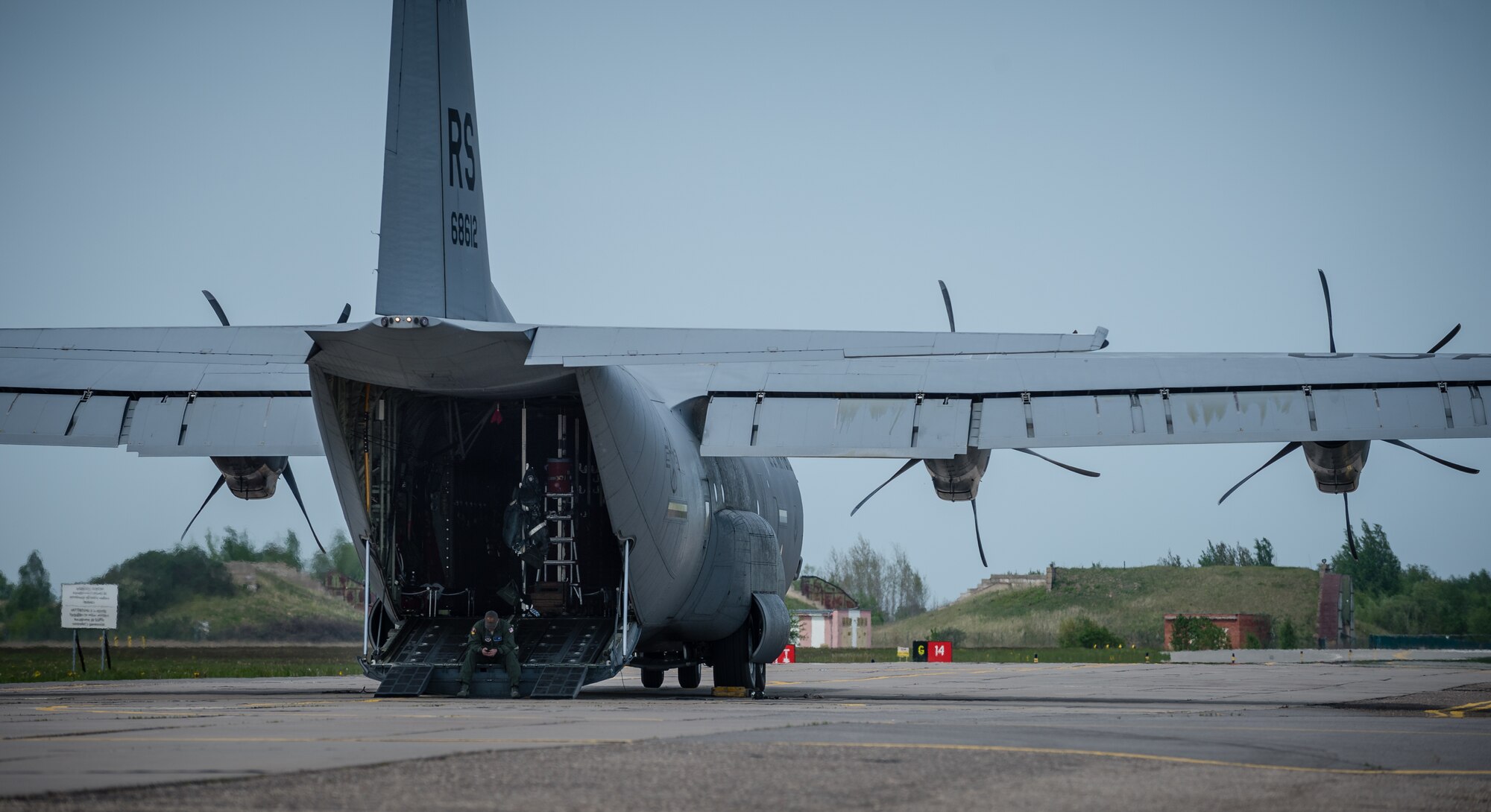 Tech. Sgt. Francis Gilson, 86th Aircraft Maintenance Squadron flying crew chief, an Andersonville, Tennesse native, waits for American service members and Lithuanian paratroopers to board a 37th Airlift Squadron C-130J Super Hercules at Šiauliai International Airport, May 17, 2014. Gilson was part of a five-man crew including 37th AS pilots and loadmasters. The team spent four days across three Baltic countries assisting in personnel drops of allied partners and American service members. (U.S. Air Force photo/Airman 1st Class Jordan Castelan)