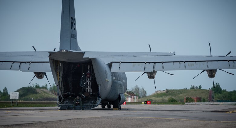 Tech. Sgt. Francis Gilson, 86th Aircraft Maintenance Squadron flying crew chief, an Andersonville, Tennesse native, waits for American service members and Lithuanian paratroopers to board a 37th Airlift Squadron C-130J Super Hercules at Šiauliai International Airport, May 17, 2014. Gilson was part of a five-man crew including 37th AS pilots and loadmasters. The team spent four days across three Baltic countries assisting in personnel drops of allied partners and American service members. (U.S. Air Force photo/Airman 1st Class Jordan Castelan)