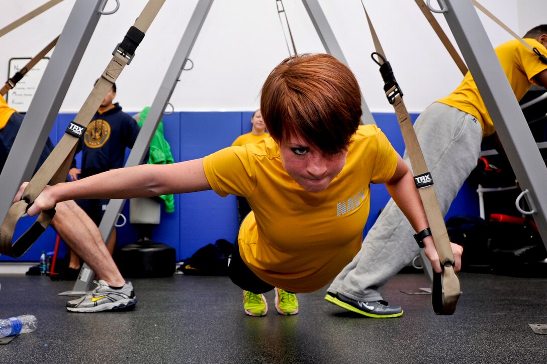 Navy Petty Officer 3rd Class Amber Ferguson participates in a suspension training class at the gym on Naval Station Everett in Everett, Wash., Dec. 18, 2012. Ferguson is an engineman assigned to the aircraft carrier USS Nimitz. Sailors who participated in the two-day class earned a certification to instruct resistance workouts aboard the ship.  
