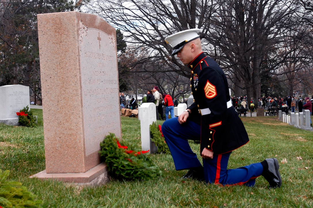 Marine Corps Staff Sgt. Micheal A. Cornelio pays respect after placing a wreath at a grave marker during Wreaths Across America at Arlington National Cemetery in Arlington, Va., Dec. 15, 2012. Cornelio is assigned to Marine Cryptologic Support Battalion on Fort Meade, Md. 

