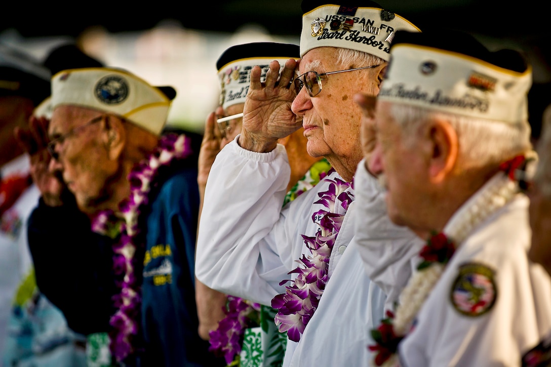 Edgar Harrison, center, a Pearl Harbor survivor and World War II veteran, salutes as the national anthem is played during a remembrance ceremony marking the 71st anniversary of the Japanese attack on Pearl Harbor and Oahu, Hawaii, at the World War II Valor in the Pacific National Monument, formerly known as the USS Arizona Memorial Visitor Center, in Honolulu, Dec. 7, 2012. The attack lasted 110 minutes, leaving 2,335 U.S. service members dead and 1,142 wounded. 
