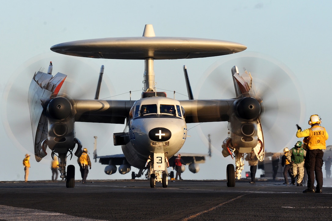 A sailor directs an E-2C Hawkeye to the catapults aboard the aircraft carrie USS Dwight D. Eisenhower under way in the Mediterranean Sea, Dec. 5, 2012. The Dwight D. Eisenhower is en route to its homeport in Norfolk, Va., after operating in the U.S. 5th and 6th Fleet areas of responsibility.  
