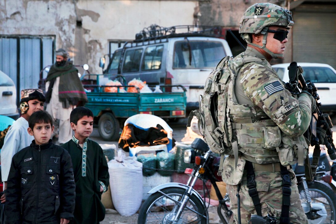 U.S. Army Spc. Samnith Thy provides security outside during a youth meeting in Farah City, Afghanistan, Dec. 2, 2012. Thy is assigned to Provincial Reconstruction Team Farah.  
