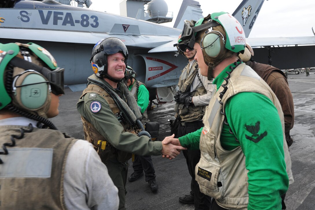 Navy Capt. Samuel Paparo shakes hands with sailors aboard the aircraft carrier the USS Dwight D. Eisenhower after his last flight as commander of Carrier Air Wing 7 in the Mediterranean Sea, Dec. 2, 2012. The Dwight D. Eisenhower is returning to her homeport of Norfolk, after operating in the U.S. 5th and 6th Fleet areas of responsibility in support of Operation Enduring Freedom, maritime security operations and theater security cooperation efforts.  
