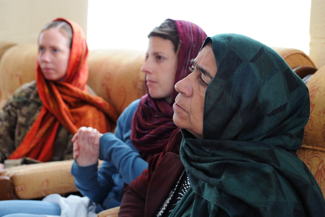 A U.S. service member, left, a U.S. civilian, center, and an Afghan woman who serves on the Farah Provincial Council, right, take part in a senior meeting on women's issues in Farah, Afghanistan, Dec. 6, 2012. The soldier is assigned to the Provincial Reconstruction Team Farah. The women's shura was held in conjunction with the 16-Day Campaign to End Violence Against Women.  
