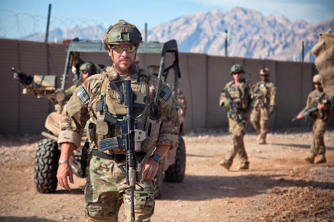 A coalition force member leads fellow troops off base for a presence patrol in Farah province, Afghanistan, Dec. 9, 2012. Coalition forces were conducting a patrol to assess the Afghan local police in the village. Afghan Local Police complement counterinsurgency efforts by assisting and supporting rural areas with limited Afghan national security forces presence.  
