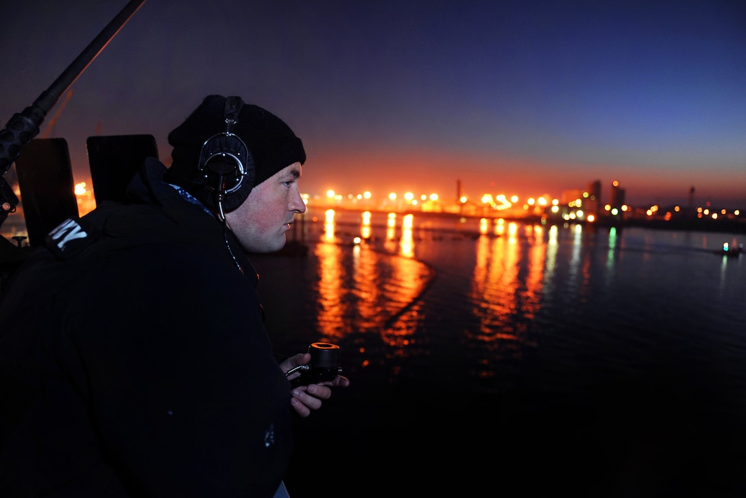 Navy Petty Officer 3rd Class John Fitzpatrick stands watch at a .50-caliber machine gun mount aboard the aircraft carrier USS George H.W. Bush before its departure from Norfolk Naval Shipyard, Portsmouth, Va., Dec. 1, 2012, to conduct sea trials. Fitzpatrick is an aviation ordnanceman.  
