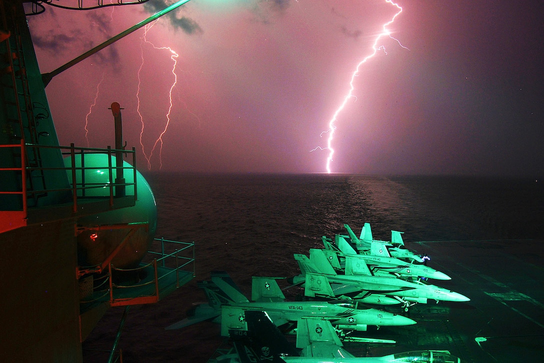 Flashes of lighting are seen over the horizon as the aircraft carrier USS Dwight D. Eisenhower operates in the U.S. 5th Fleet area of responsibility, Nov. 19, 2012.  
