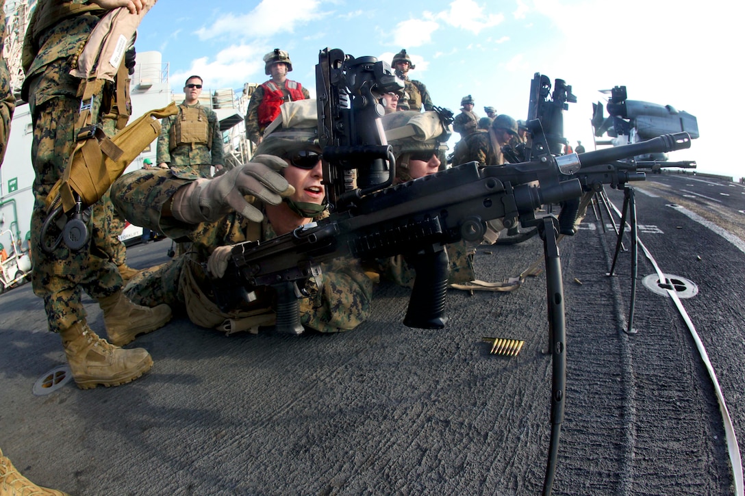 U.S. Marine Corps Lance Cpl. Joshua Allen loads his M249 squad automatic weapon during a live-fire training exercise to confirm his distance target setting aboard the USS Iwo Jima, Nov. 25, 2012. He is assigned to Bravo Company, Battalion Landing Team 1st Battalion 2nd Marine Regiment, 24th Marine Expeditionary Unit.  
