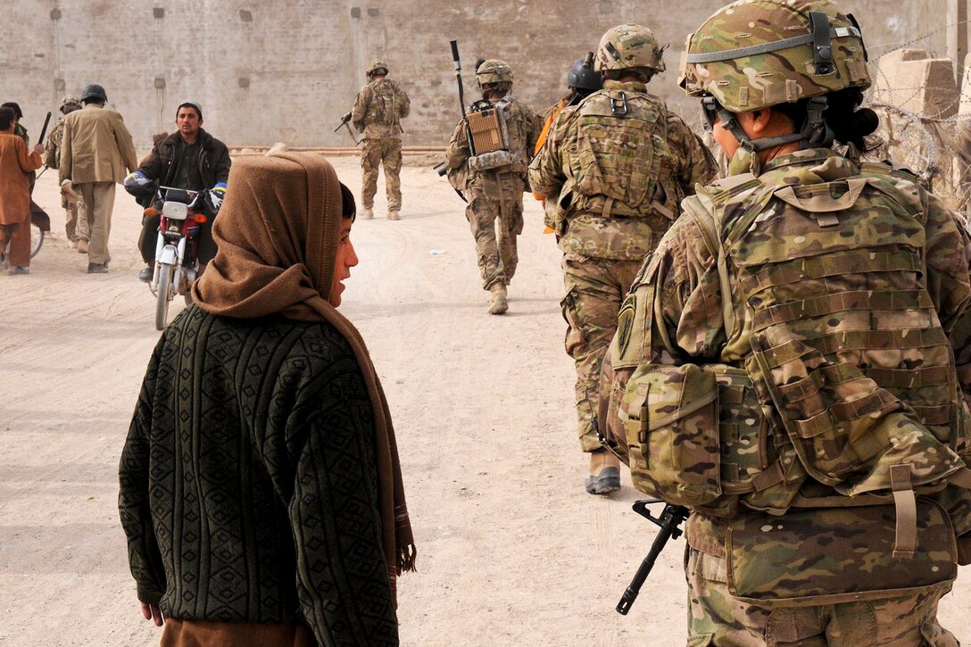 U.S. Army Capt. Peggy Hu, Zabul Provincial Reconstruction Team civil affairs officer, speaks with a local child during a routine patrol in the Zabul Province, Afghanistan, Nov. 21, 2012.  
