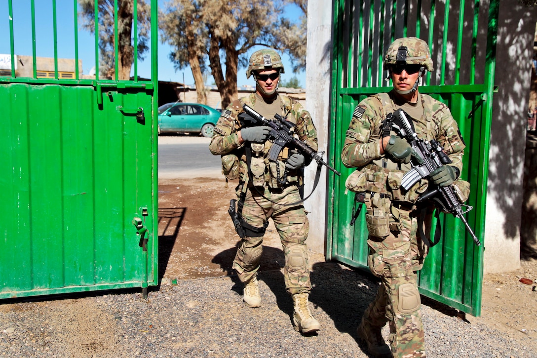 U.S. Army Spc. Joseph Gonzalez, right, and U.S. Army Sgt. Sean Luhmann return after speaking with Afghans during a key leader engagement in Farah City in Afghanistan's western Farah province, Nov. 18, 2012. Gonzalez and Luhmann are assigned to Provincial Reconstruction Team Farah.  
