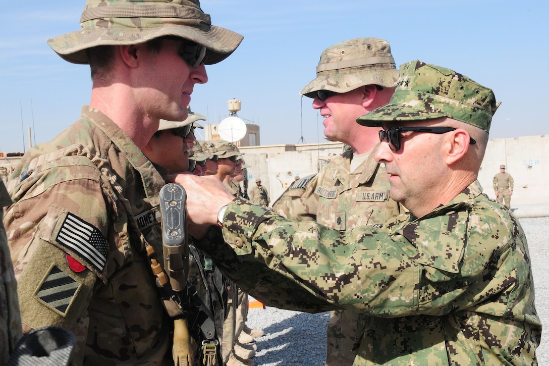 U.S. Navy Adm. James G. Stavridis, right, NATO's supreme allied commander for Europe and commander of U.S. European Command, pins an Army Commendation Medal on a soldier at Combat Outpost Sperwan Ghar, Afghanistan, Nov. 14, 2012.  
