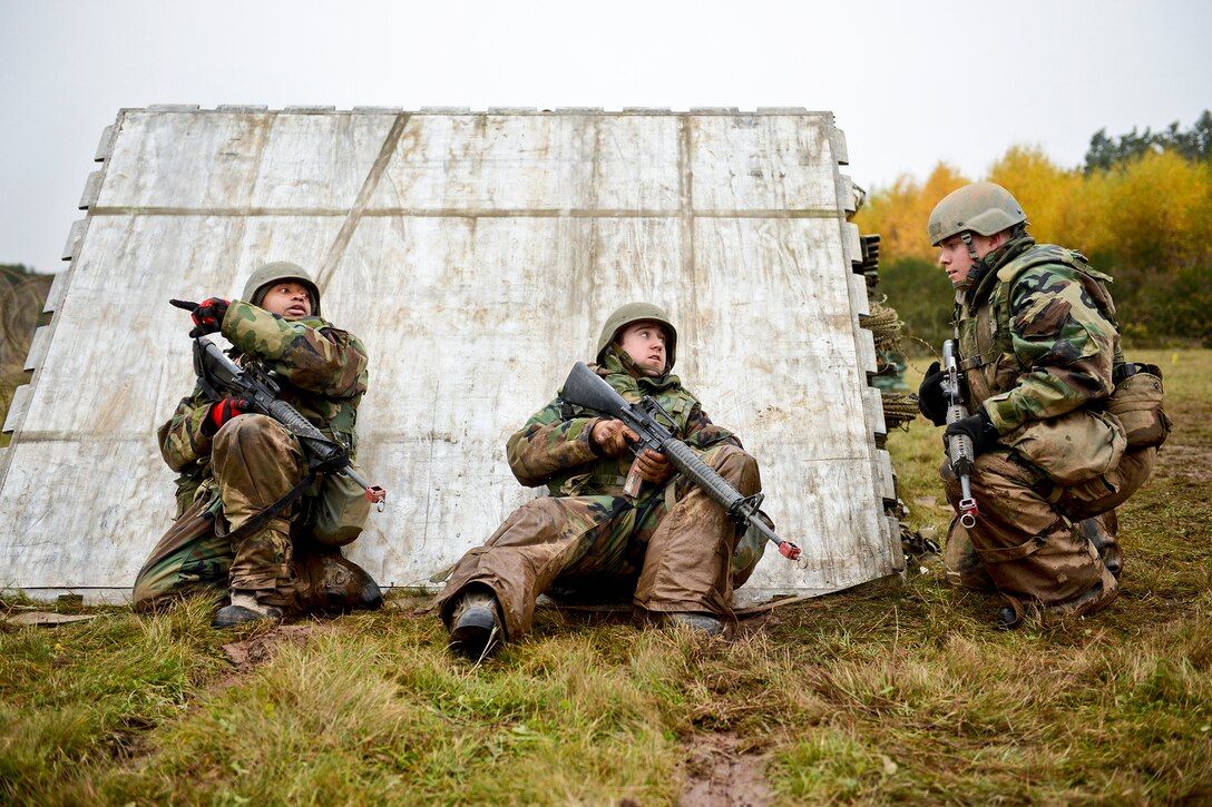 U.S. Airmen try to pinpoint the source of gunfire outside the perimeter of their base during combat readiness training on Spangdahlem Air Base, Germany, Nov. 15, 2012. The training tested their ability to defend their base through use of force, cultural awareness, indirect fire and unexploded ordnance scenarios. The airmen are assigned to the 606th Air Control Squadron.  
