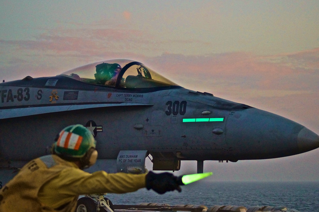 An aircraft launch and recovery officer gives the signal to launch an F/A-18C Hornet in the U.S. 5th fleet area of responsibility, Nov. 9, 2012. The Dwight D. Eisenhower is conducting maritime security operations, theater security cooperation efforts and support missions for Operation Enduring Freedom. The Hornet is assigned to Strike Fighter Squadron 83.  
